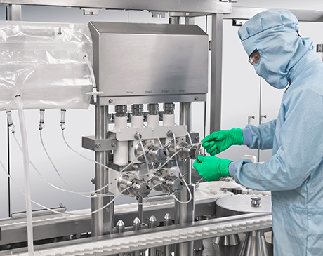 Pharmaceutical filling machine with single-use tubing and multiple filling heads, designed for aseptic liquid dosing in sterile cleanroom environments.