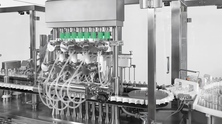 Combi-filling system integrated into a pharmaceutical filling machine, equipped with multiple nozzles and flexible tubing for handling different container types in aseptic production.